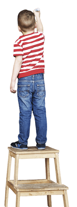 A boy stand in front of blackboard